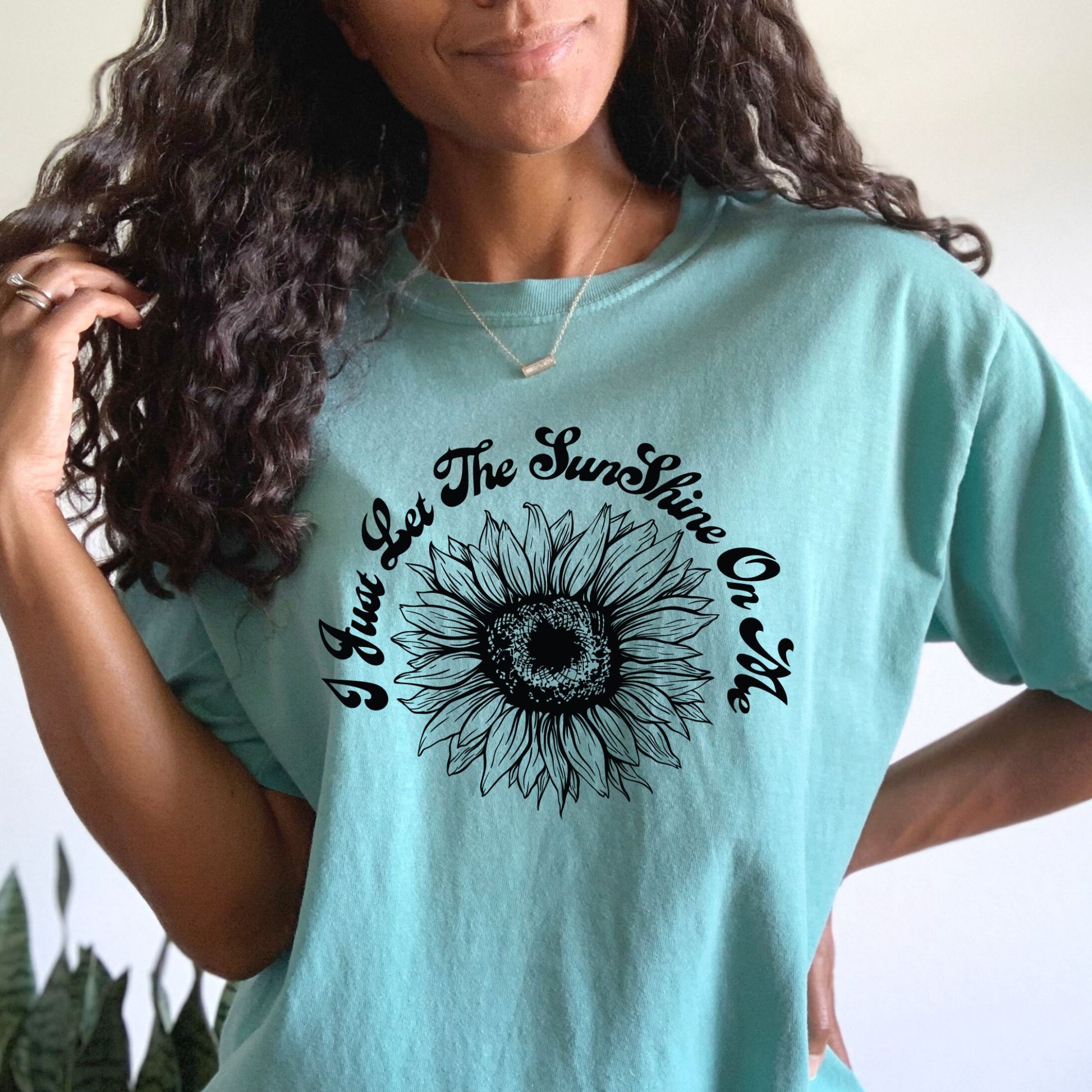 This is a black plastisol ink screen printed transfer with the quote "I just let the sunshine on me". It also has a fun sunflower in the center.