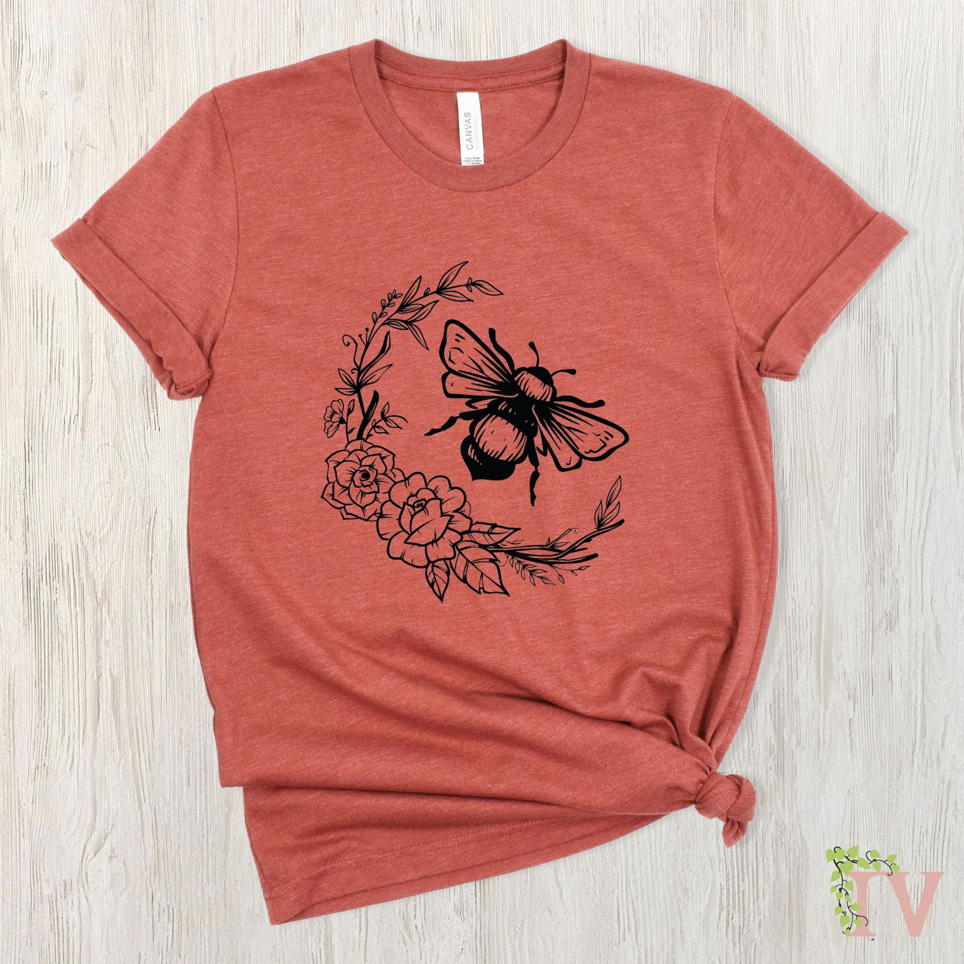 Bee with a flower border screen print transfer, which is made from black plastisol ink